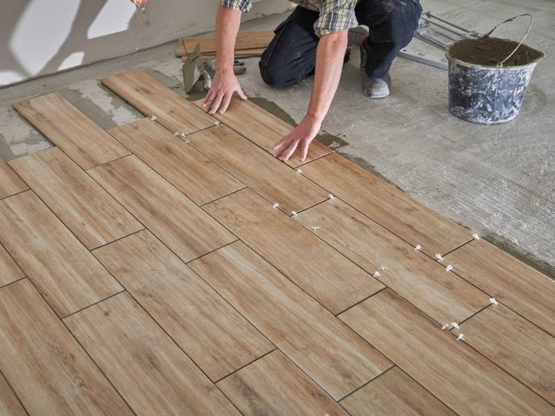 professional-installing-wood-tile-flooring